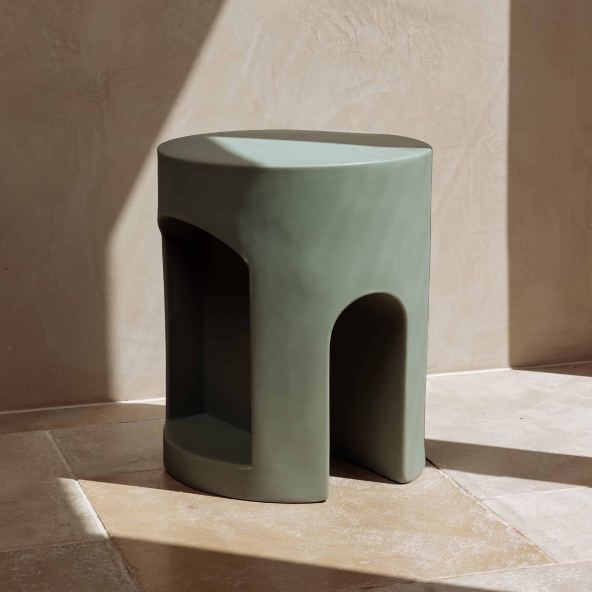 Ecommerce photography for a luxury bathroom stool by The Smallest Room sits on travertine tiles in morning sunlight