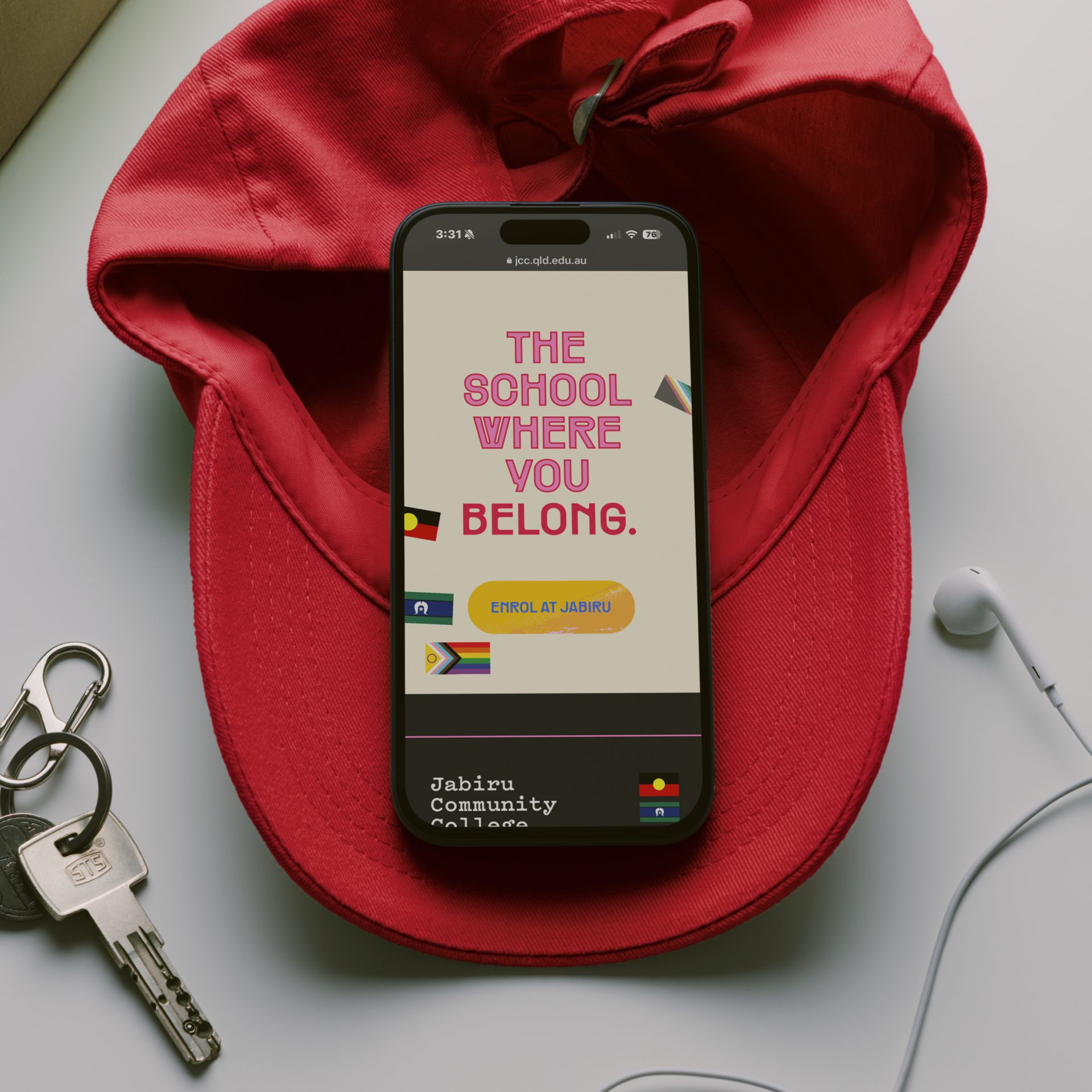 Mobile website homepage showing animated diversity flags as graphics and a bright, bold headline for Jabiru Community College, featuring a bright, bold, clean aesthetic.