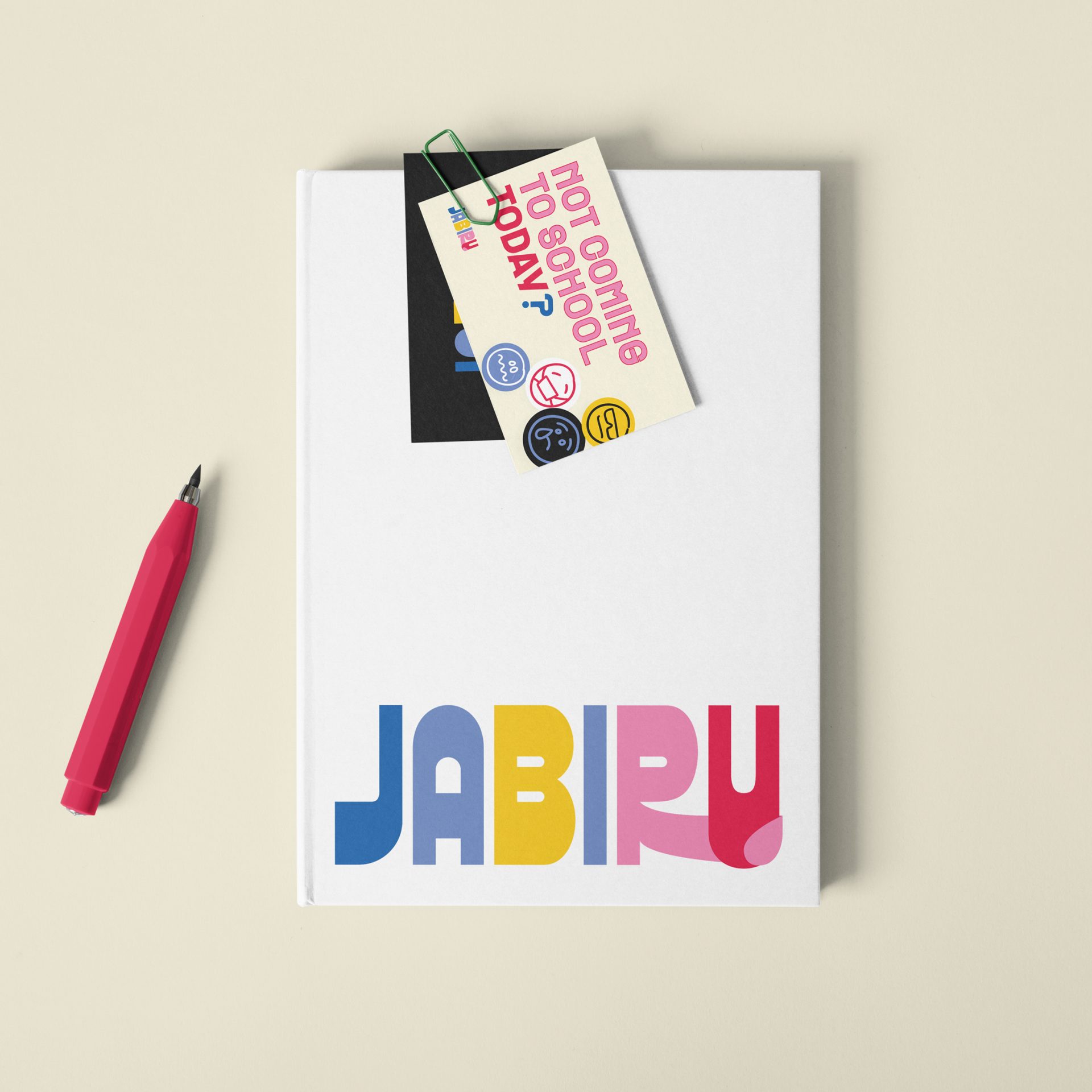 Notebook showing a custom logo design Jabiru Community College, featuring a bright, bold, clean aesthetic and queer-friendly rainbow tones.